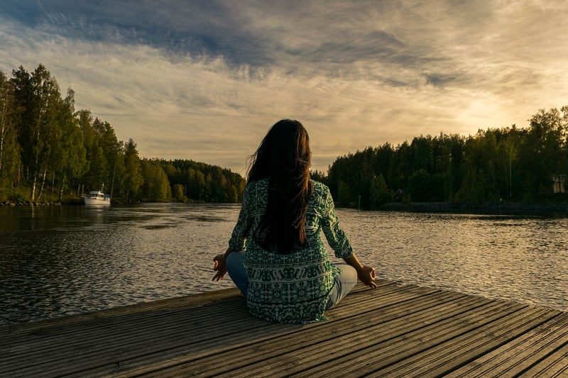 Woman meditating during sunset